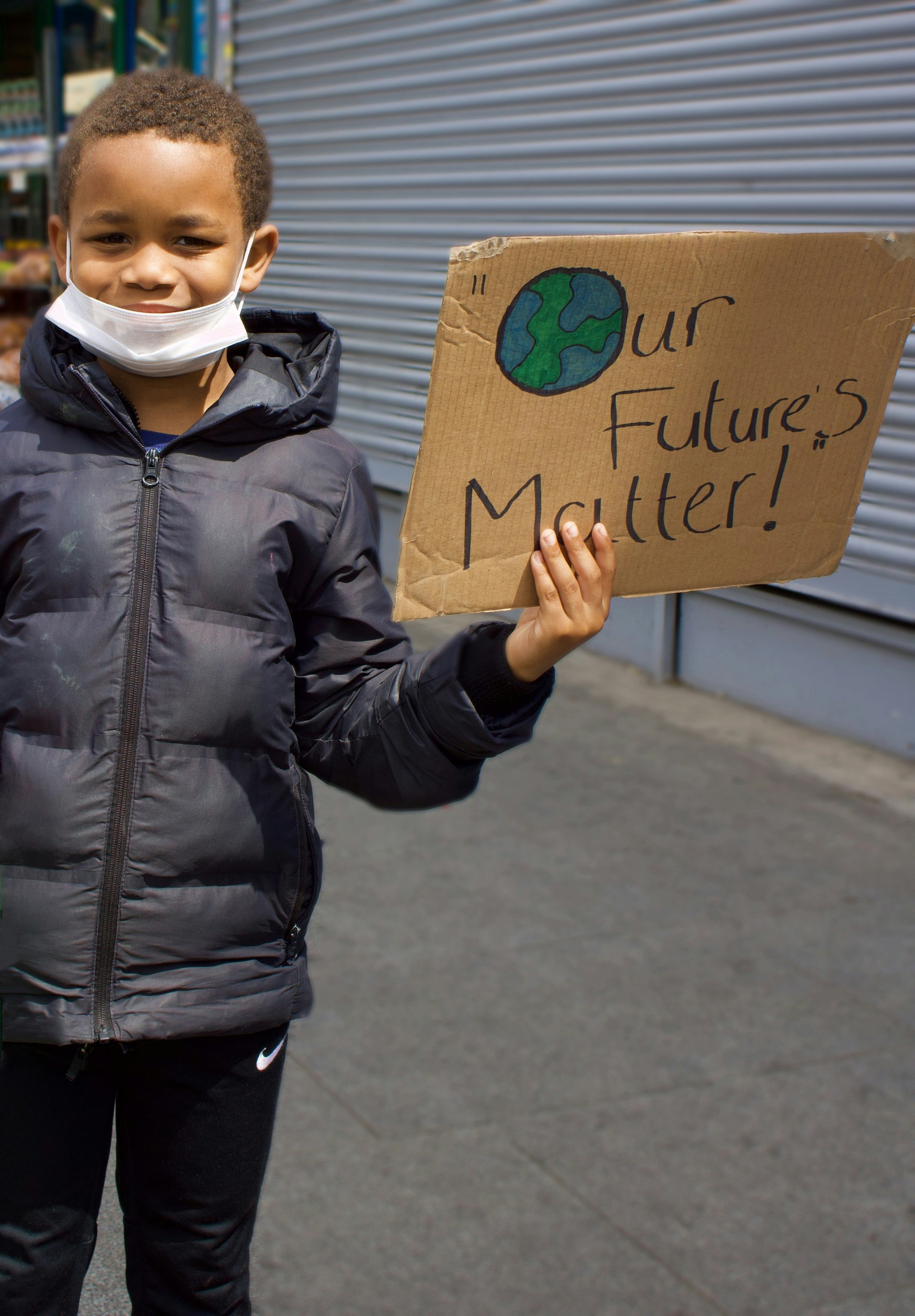 Young person holding a sign about students' future