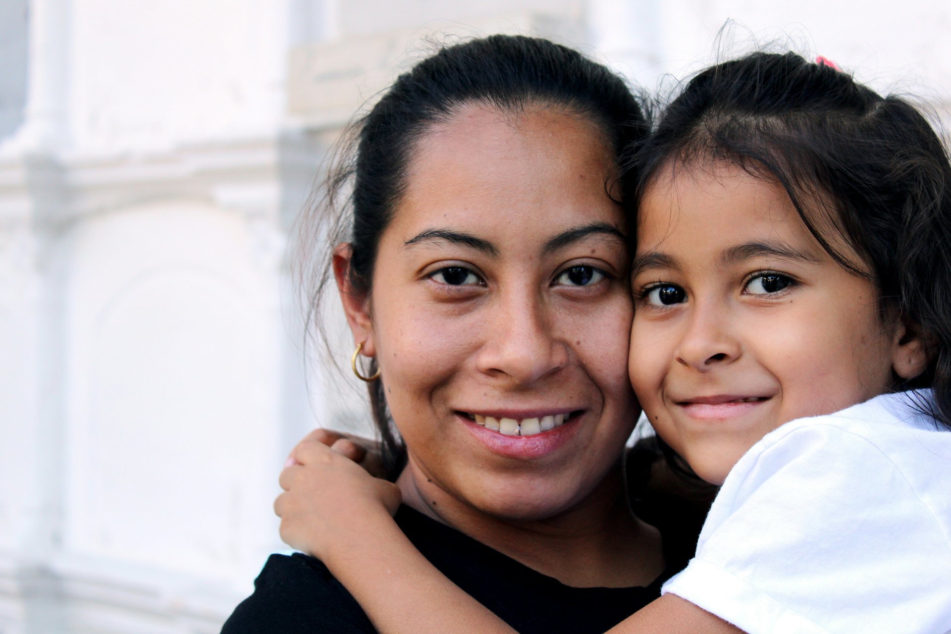 Immigrant mother and child walking confidently together