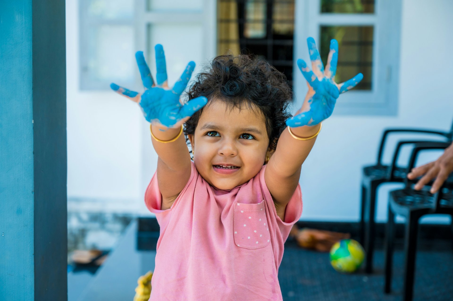 Child with painted hands, representing creative expression at a protest