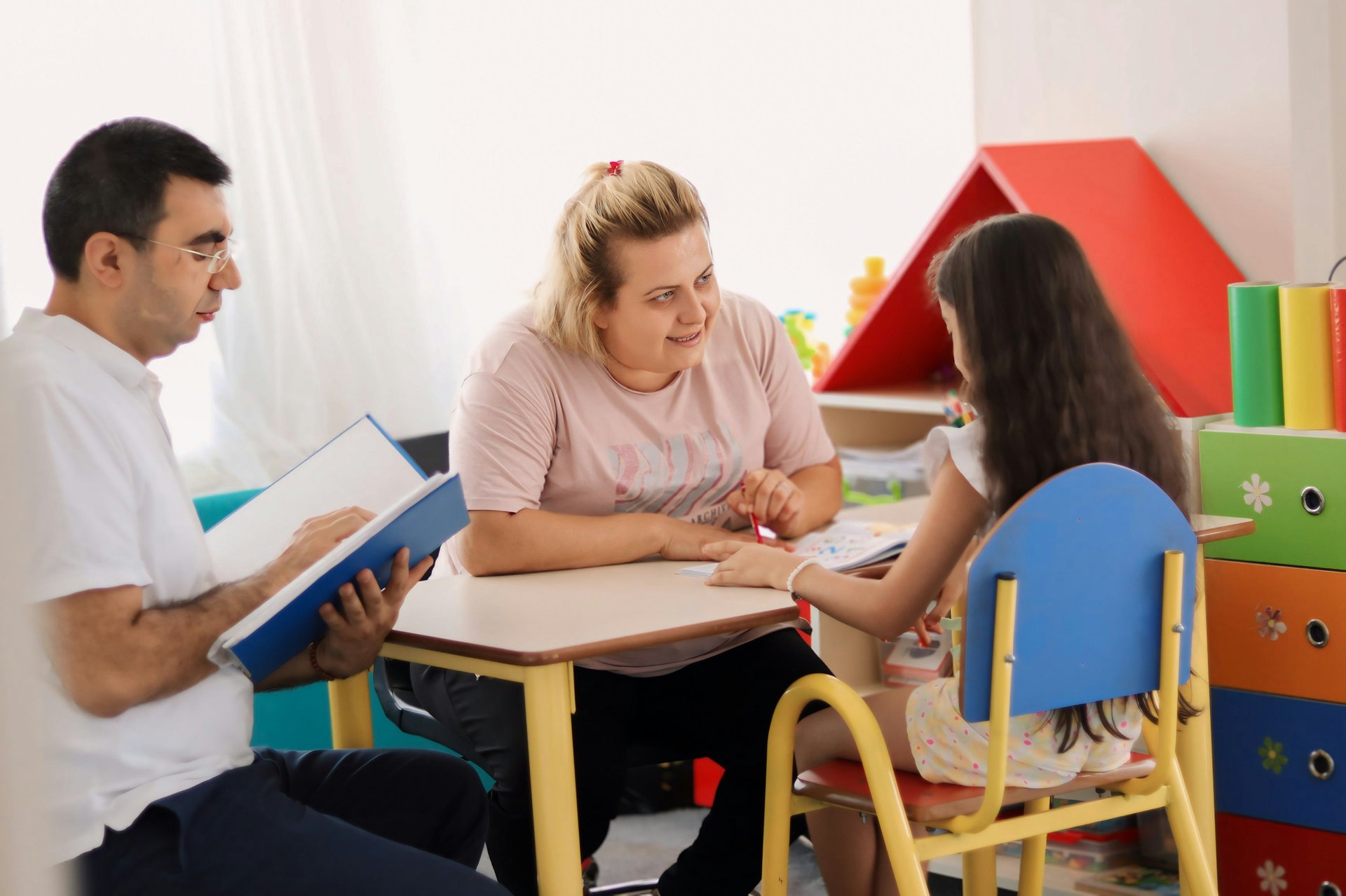 Parent and teacher talking with a student