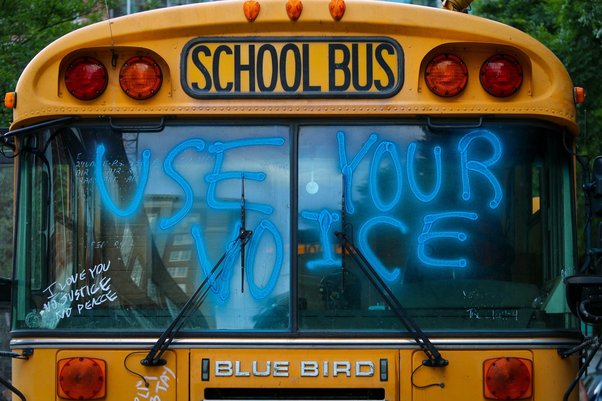 School bus with 'Use your voice' painted on the side