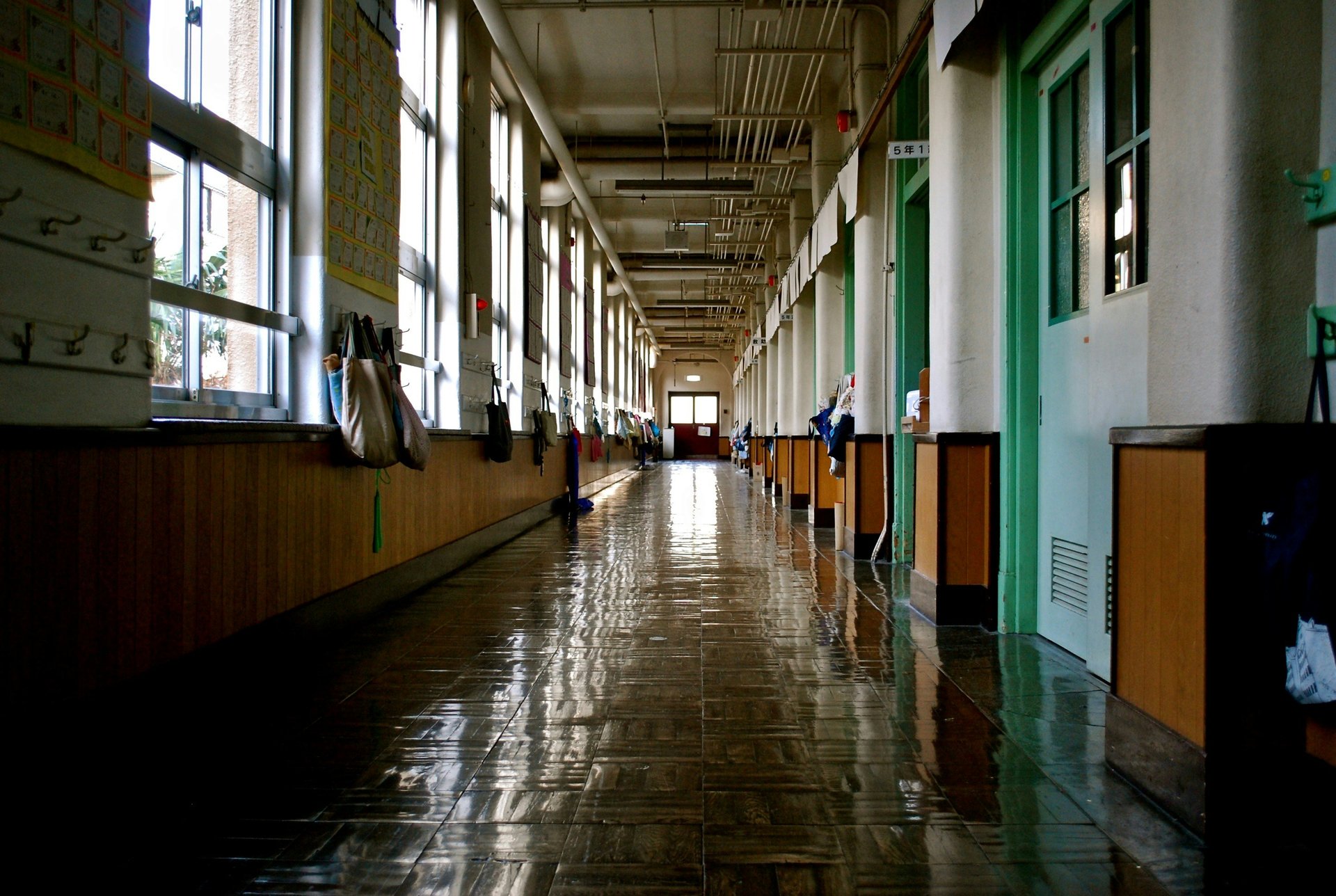 Students walking through a middle or high school hallway with lockers